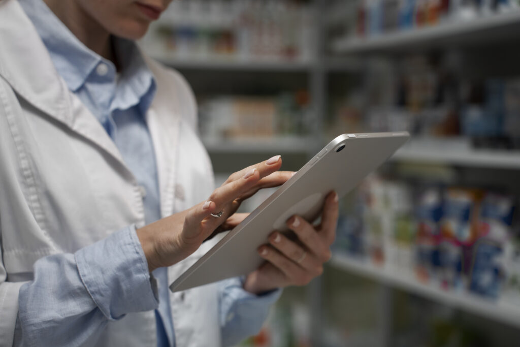 female pharmacist with table checking stock pharmacy